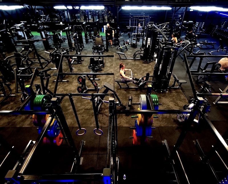 Members training among the resistance machines, cable stations and benches at TT Fitness